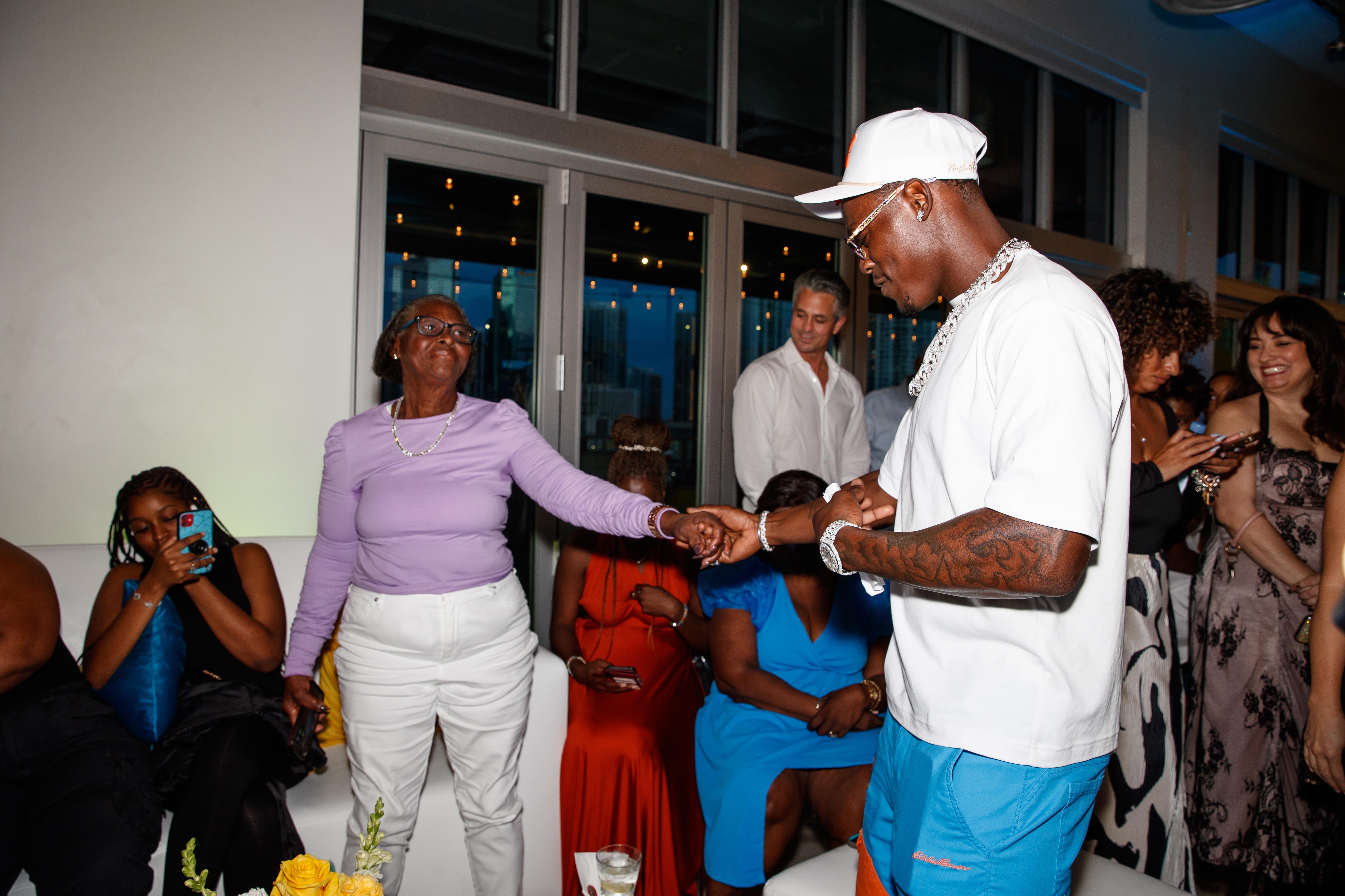 Chisholm with his grandmother at the first JCF Tunnel Fits & Kicks Fashion Show in Miami in 2023;photo courtesy of the Jazz Chisholm Foundation.
