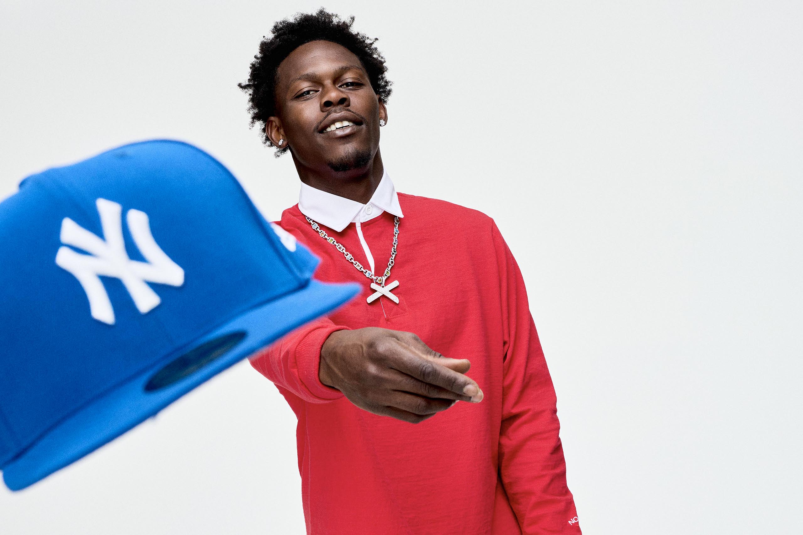 Jazz Chisholm Jr. tossing a Yankee hat
