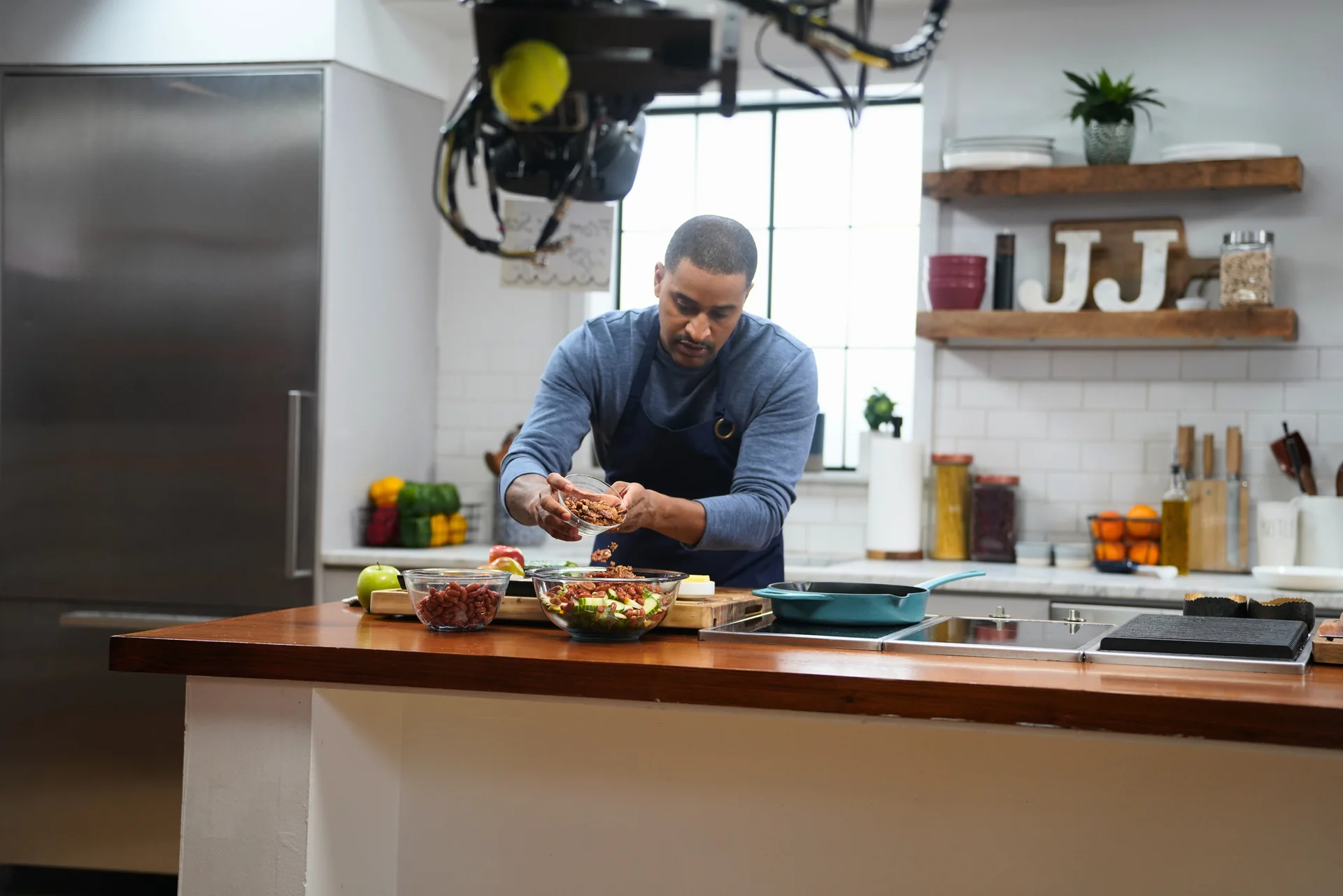 Chef JJ Johnson plating a dish in his studio kitchen