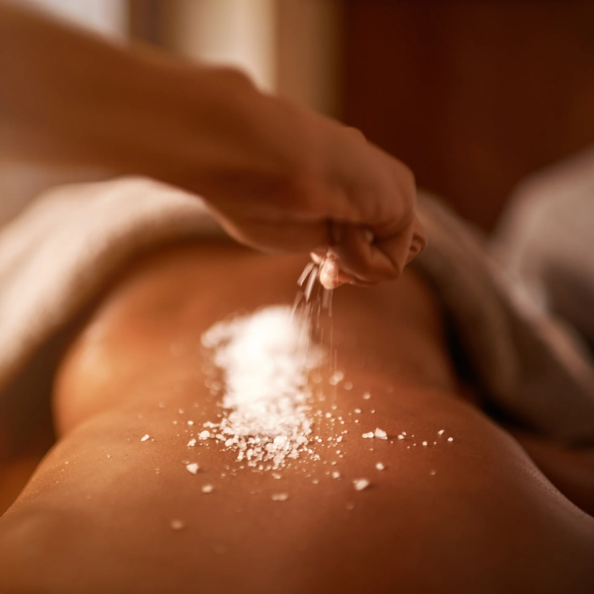 A guest receiving a salt treatment massage at Mandara Spa