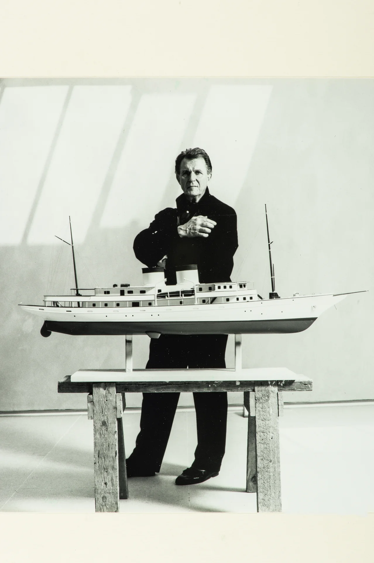 Legendary yacht designer Jon Bannenberg with a yacht model