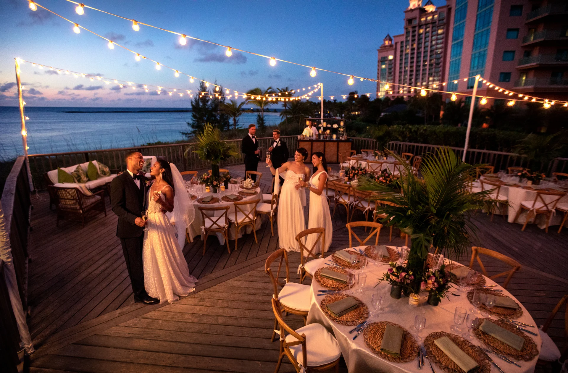 A bridal party dinner on The Ocean's Edge deck at Atlantis at dusk